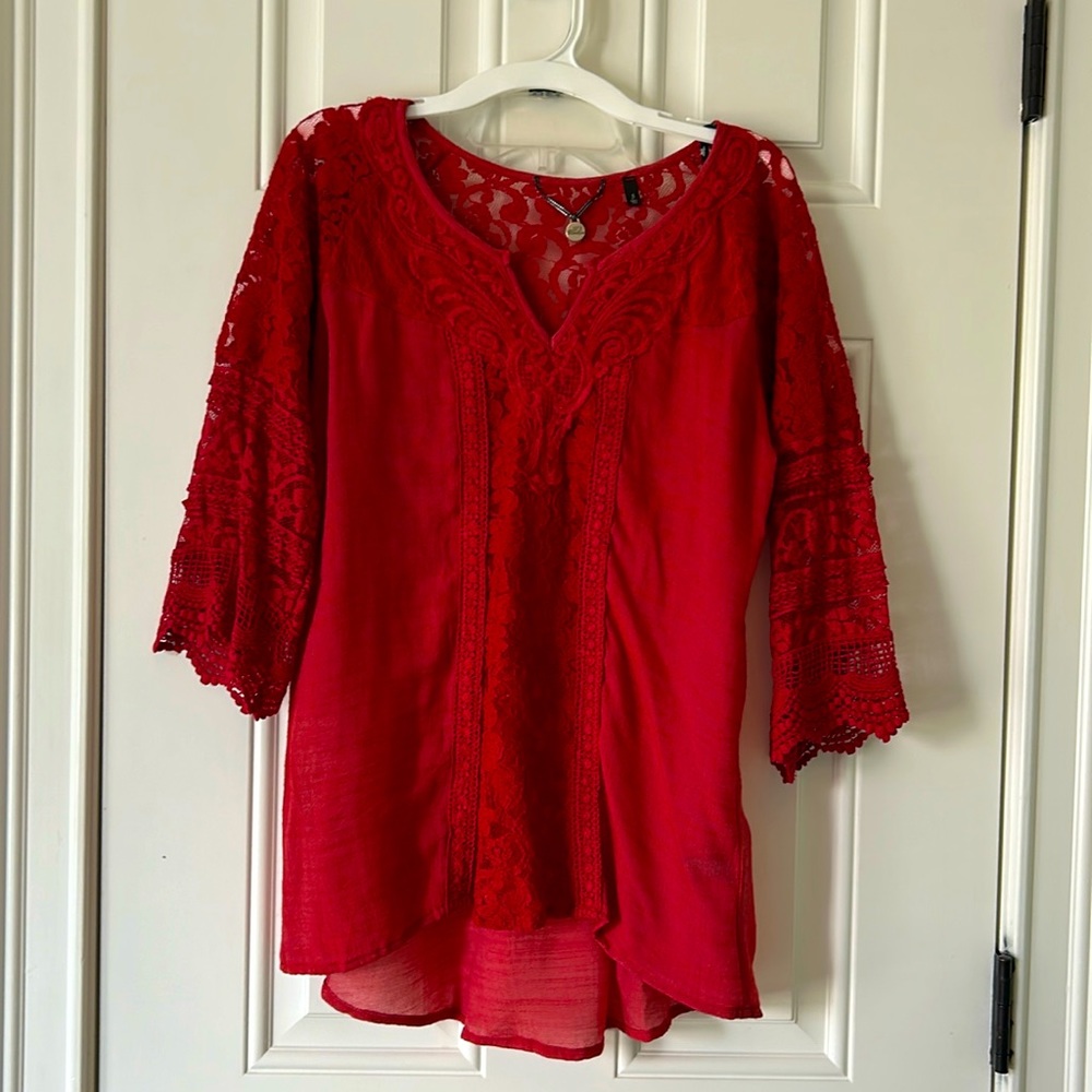 Women's red top with beautiful lace detailing on front, sleeves and back.